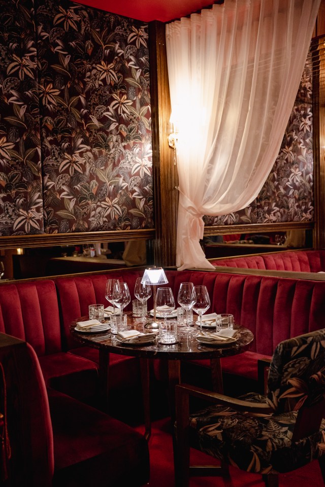 Table settings and private velvet booths inside the new speakeasy