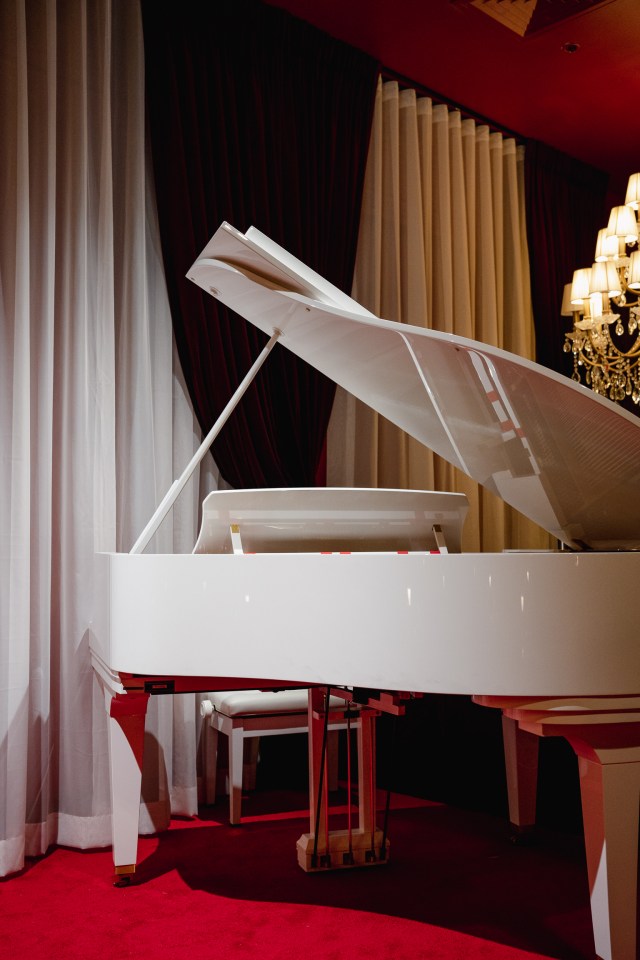 The white grand piano inside of Cardea
